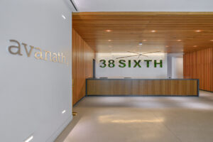Interior Entrance, Modern front desk, large 38 Sixth signage behind front desk, high quality concrete floor.