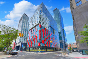 Exterior Building, Street View of 38 Sixth, red accents on windows, multi tiered high rise.